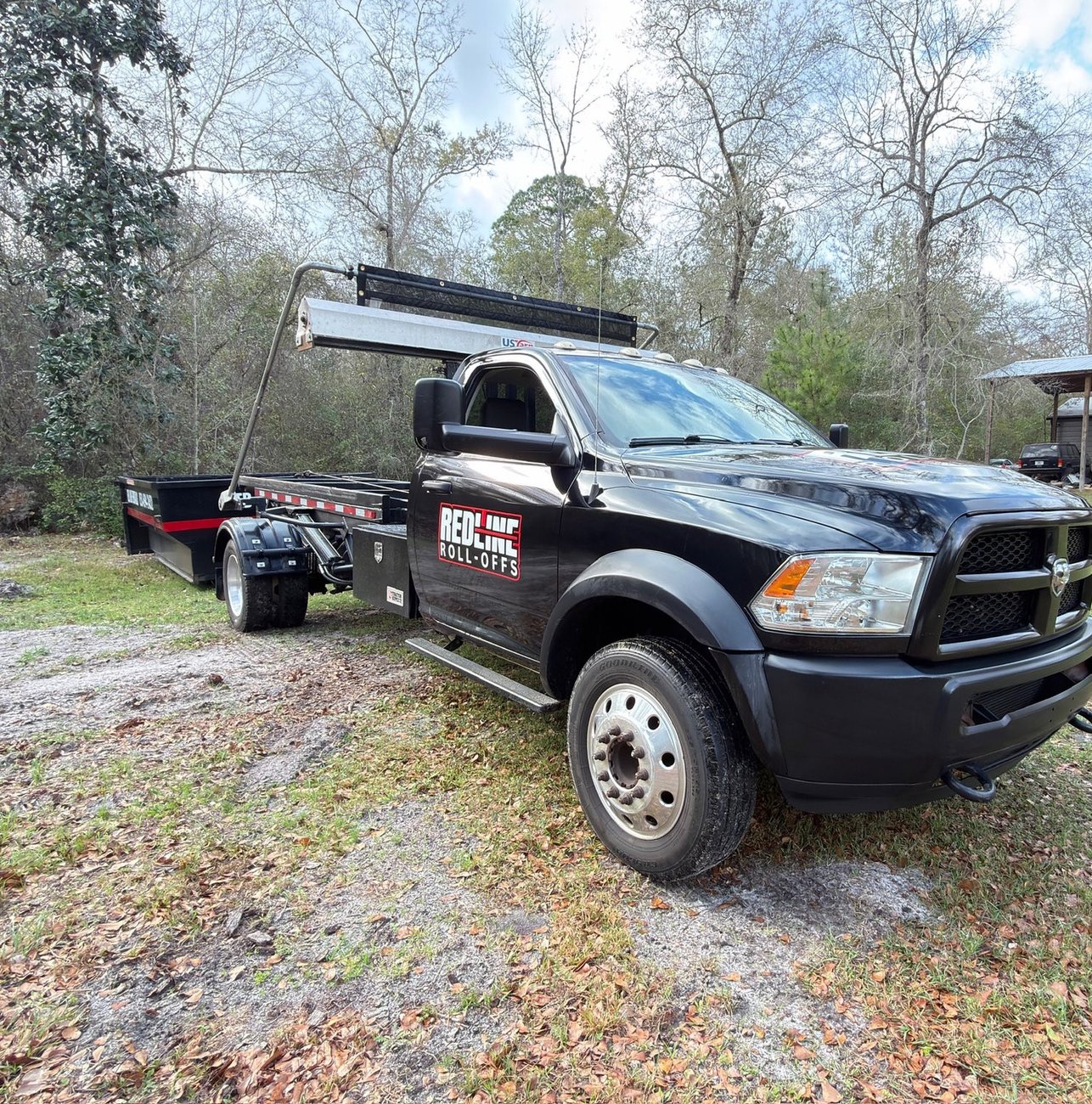 Red Line Rentals roll-off dumpster at a residential cleanout in Lanark Village, FL