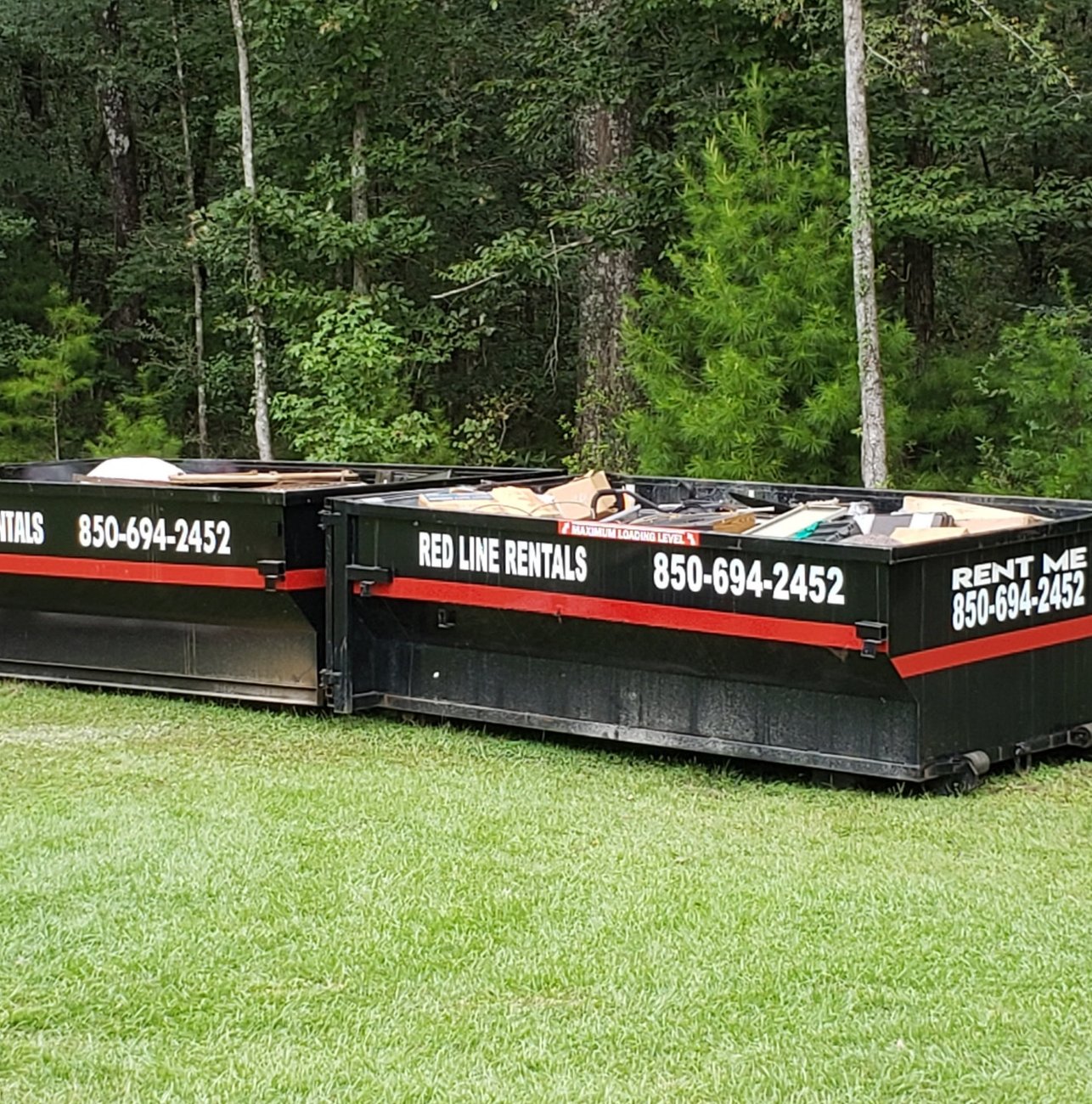 Red Line Rentals roll-off dumpster on a Tallahassee, FL job site
