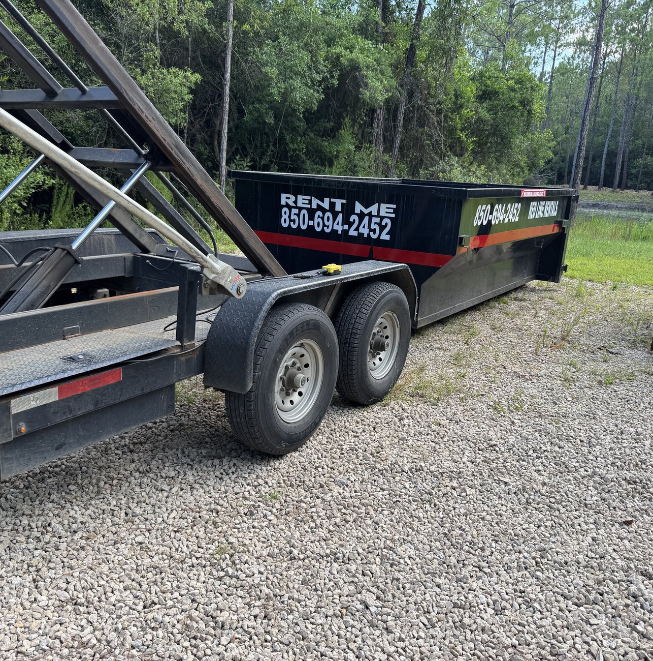 Red Line Rentals roll-off dumpster ready for pickup in Ochlockonee, FL