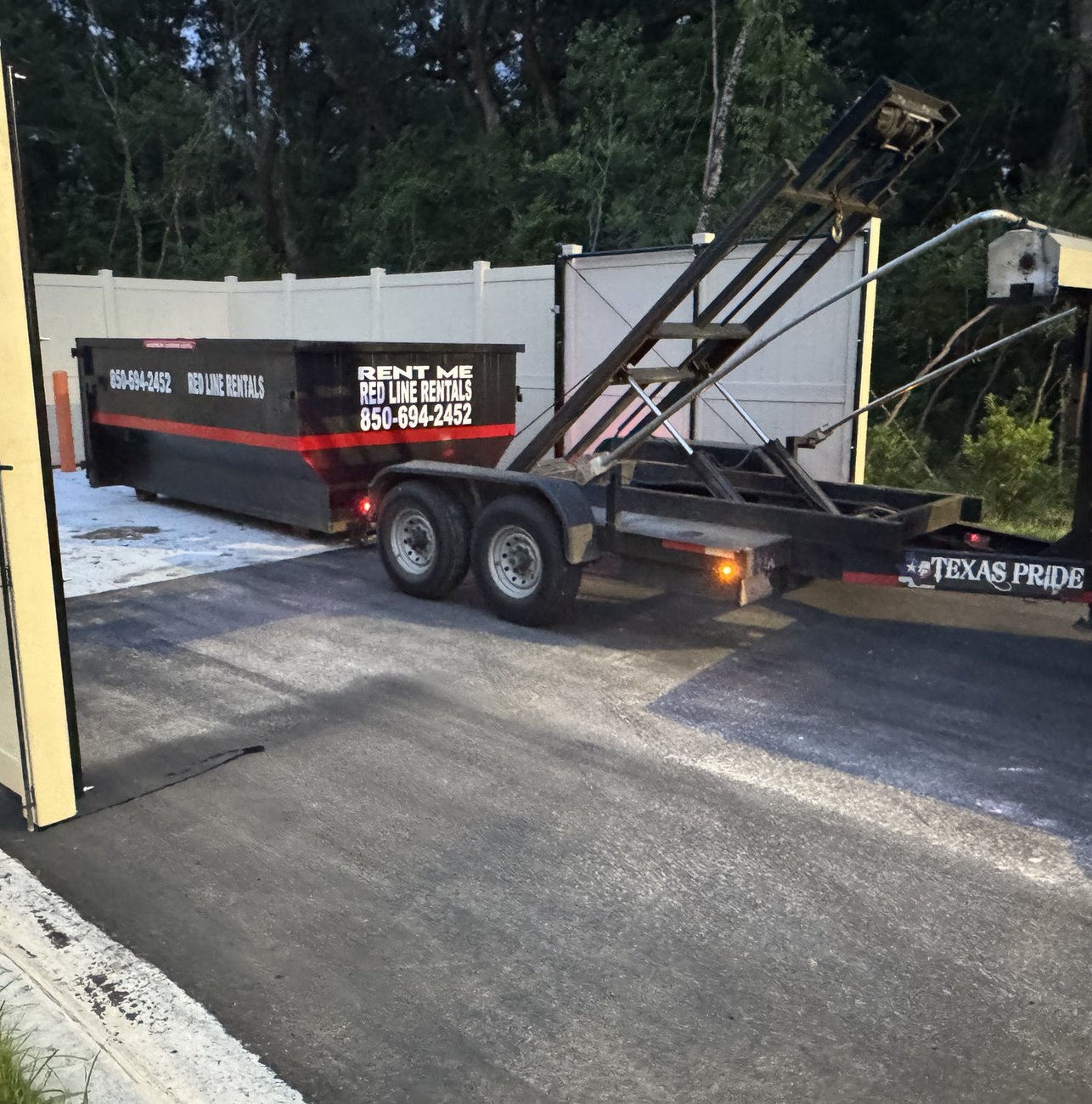 Red Line Rentals roll-off dumpster at a commercial job site in Lanark Village, FL