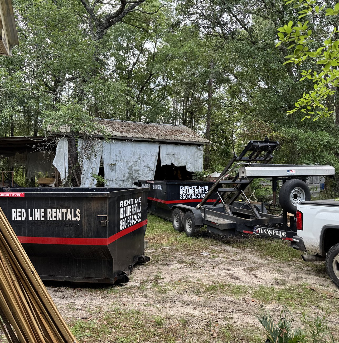 Red Line Rentals roll-off dumpster at a commercial job site in Tallahassee, FL