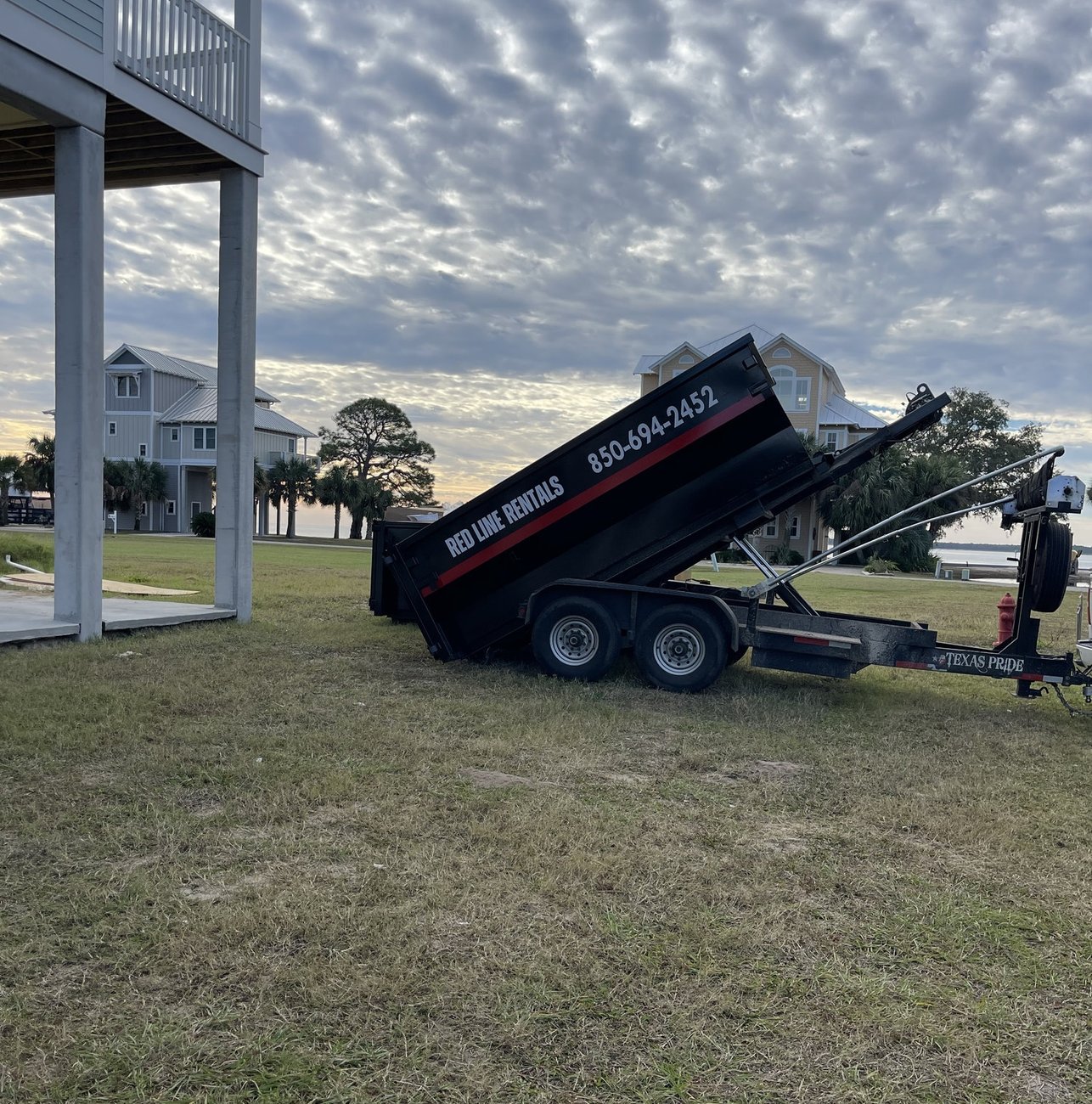 Red Line Rentals roll-off dumpster at a residential cleanout in Carrabelle, FL