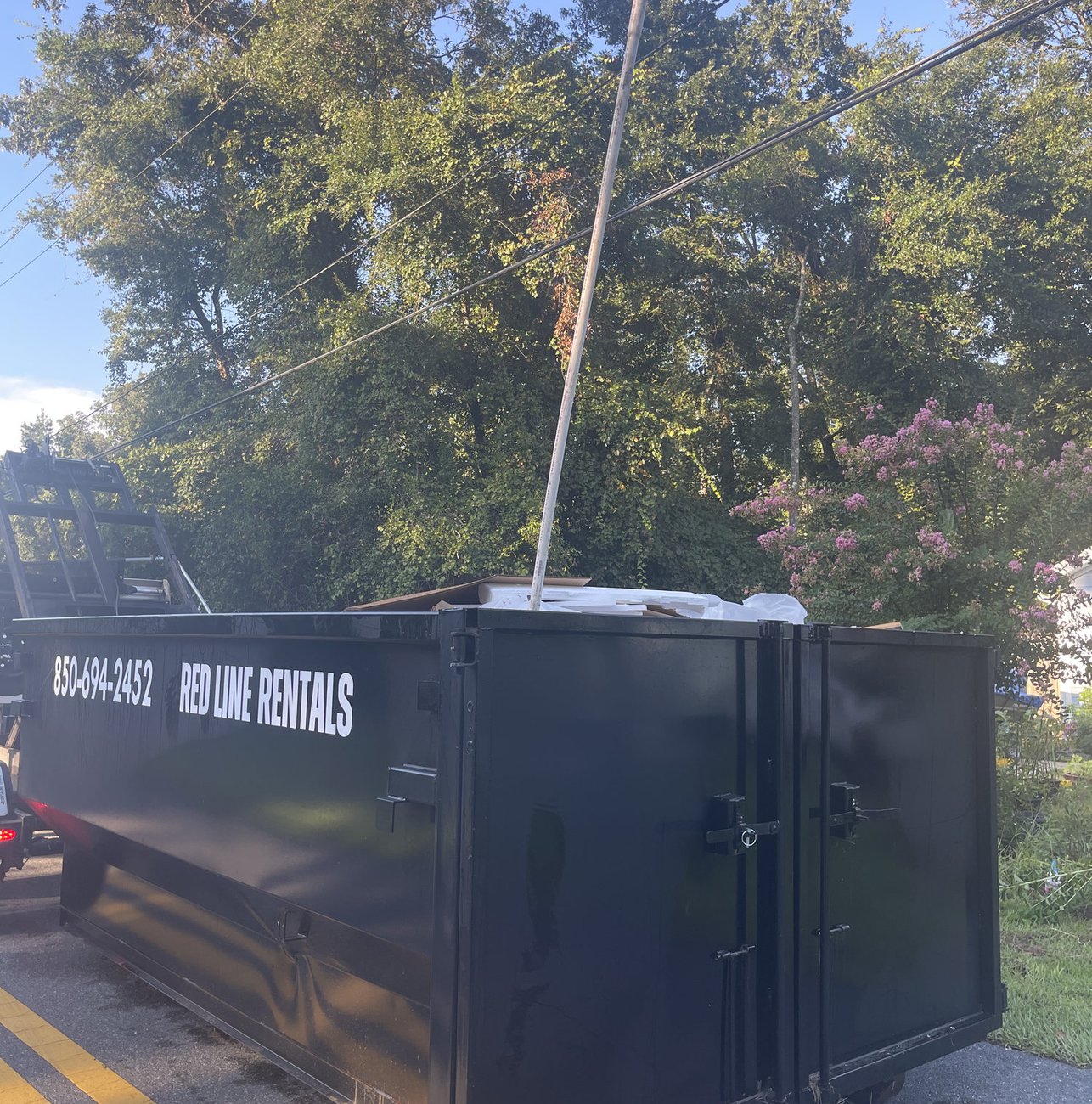 Red Line Rentals roll-off dumpster ready for pickup in Medart, FL