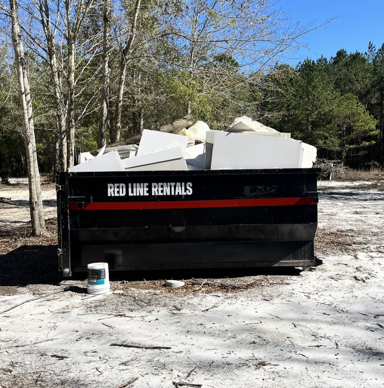 Red Line Rentals roll-off dumpster at a residential cleanout in Medart, FL
