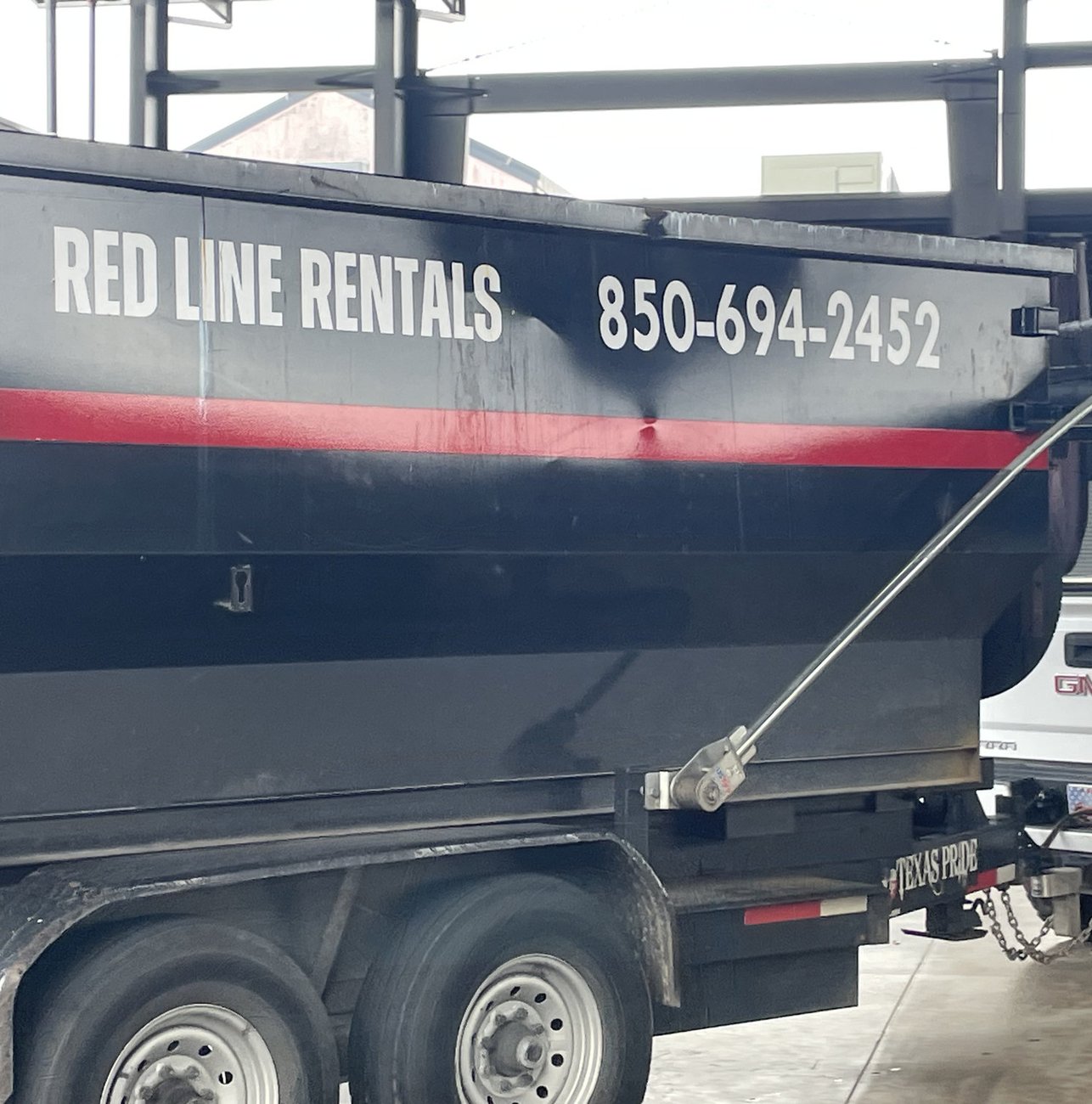 Red Line Rentals roll-off dumpster on a Ochlockonee, FL job site