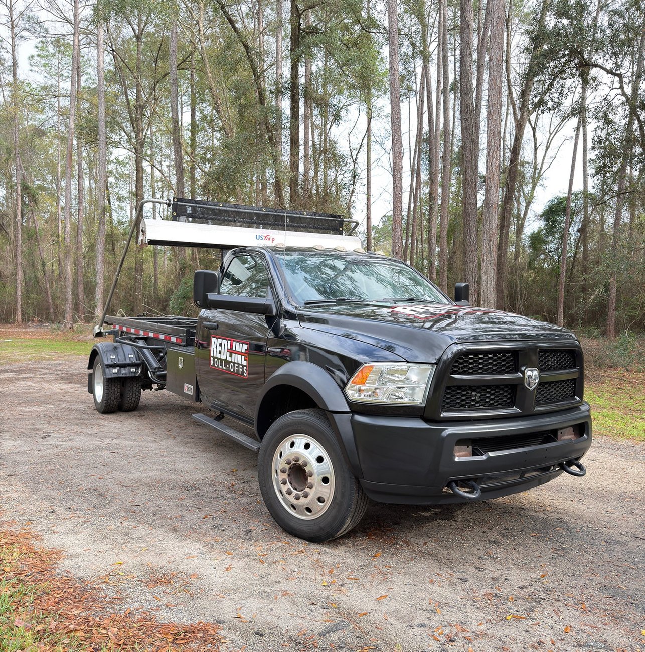 Red Line Rentals roll-off dumpster at a residential cleanout in Woodville, FL