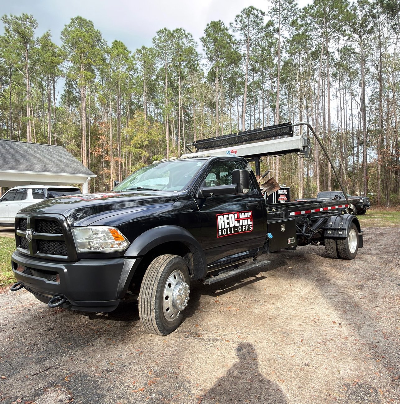 Red Line Rentals roll-off dumpster at a commercial job site in Carrabelle, FL